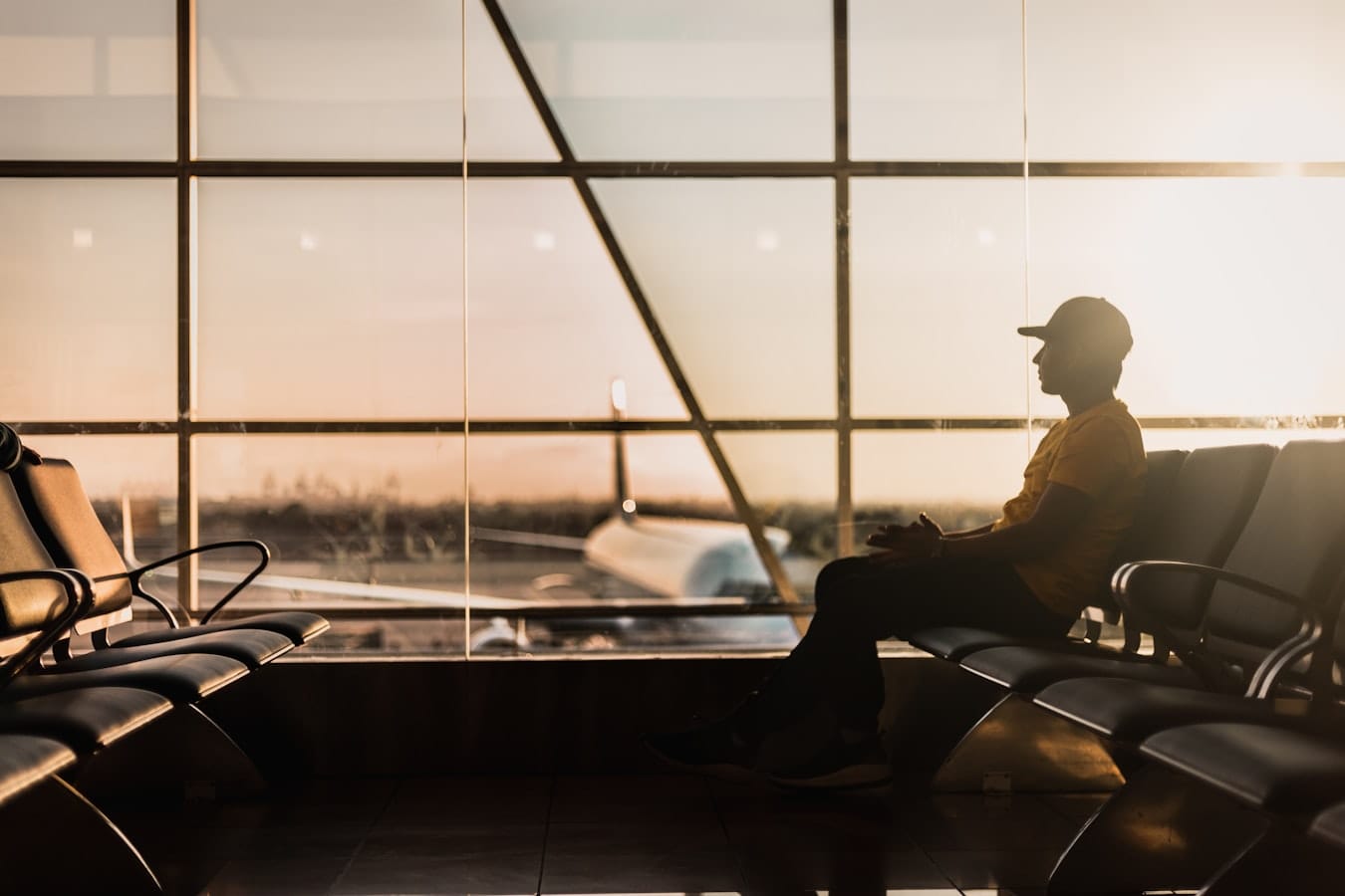 Traveler checking eSIM data usage on a phone at an airport lounge