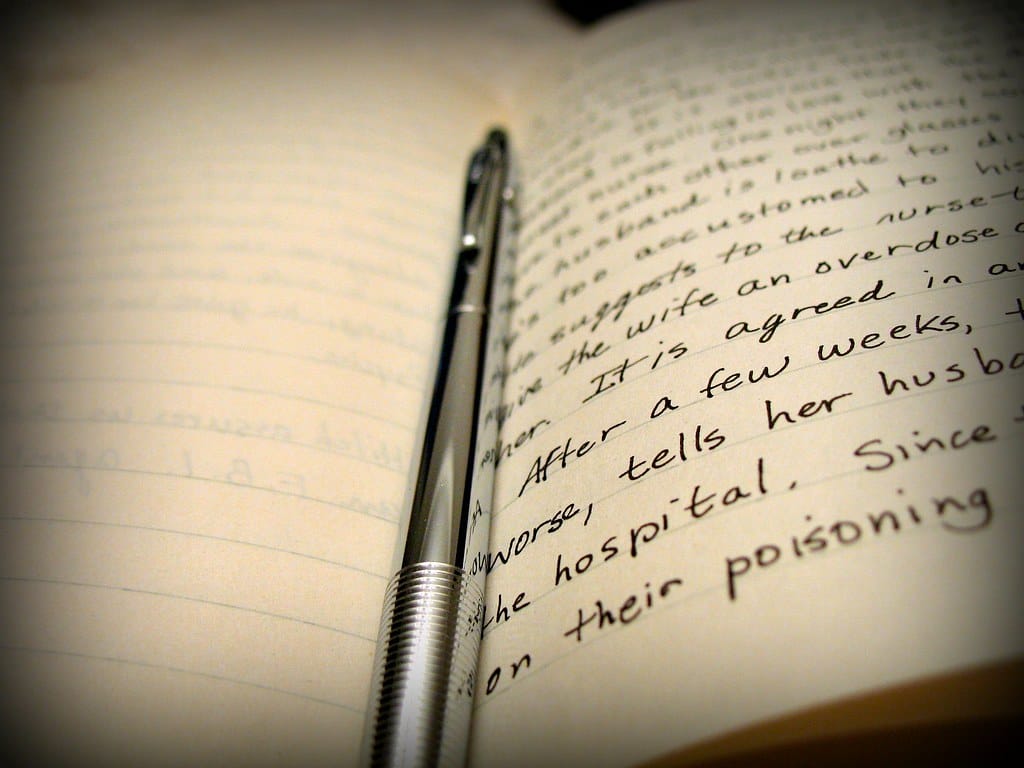 A notebook and pen drafting a carefully ranked list