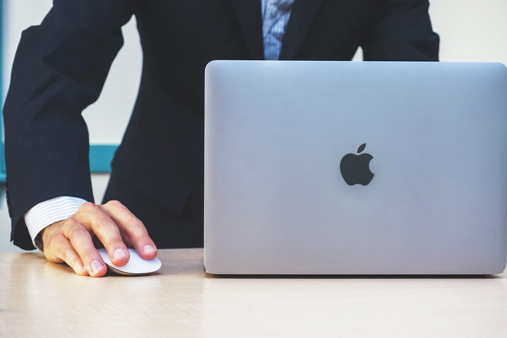 Marketer drafting content on a laptop inside an AI pipeline