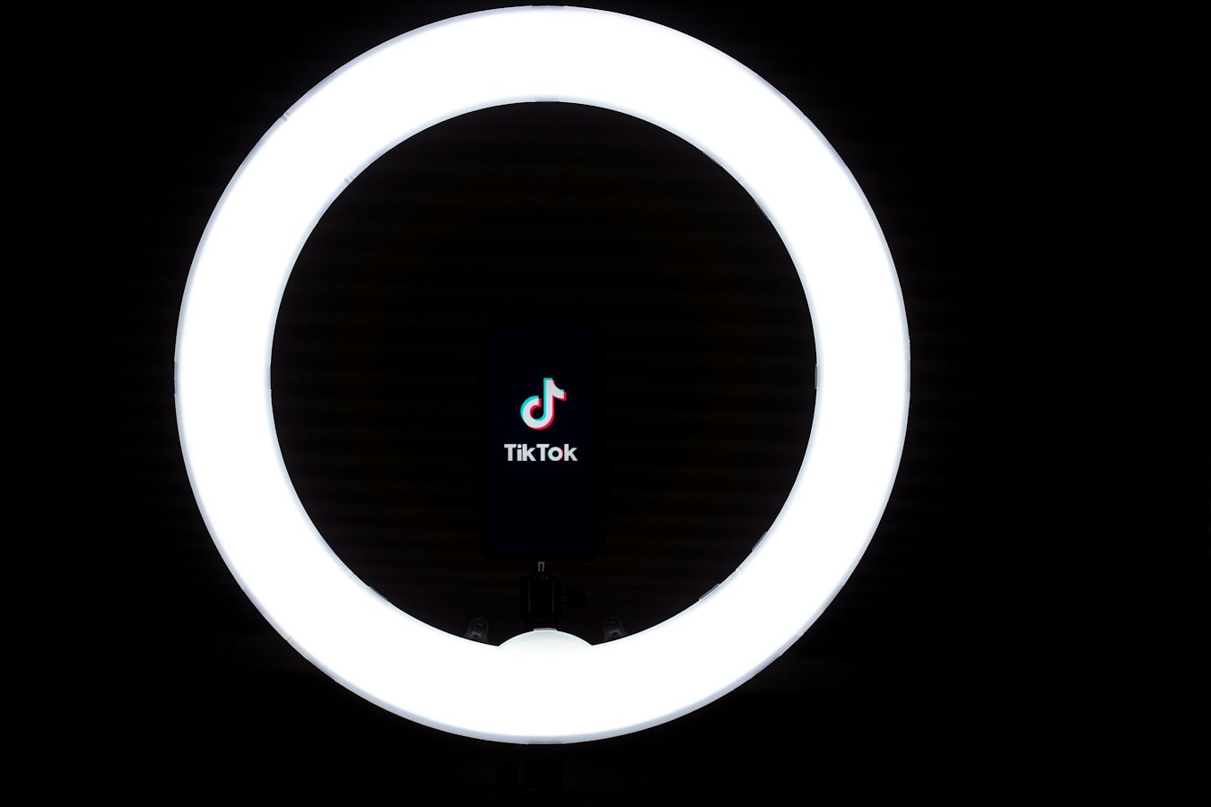 A creator recording collaboration content with a ring light