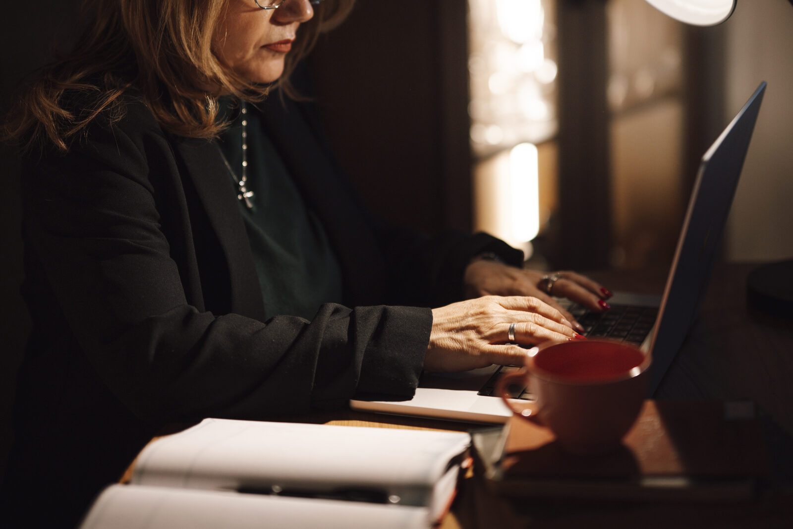 Professional working on laptop preparing content and reports