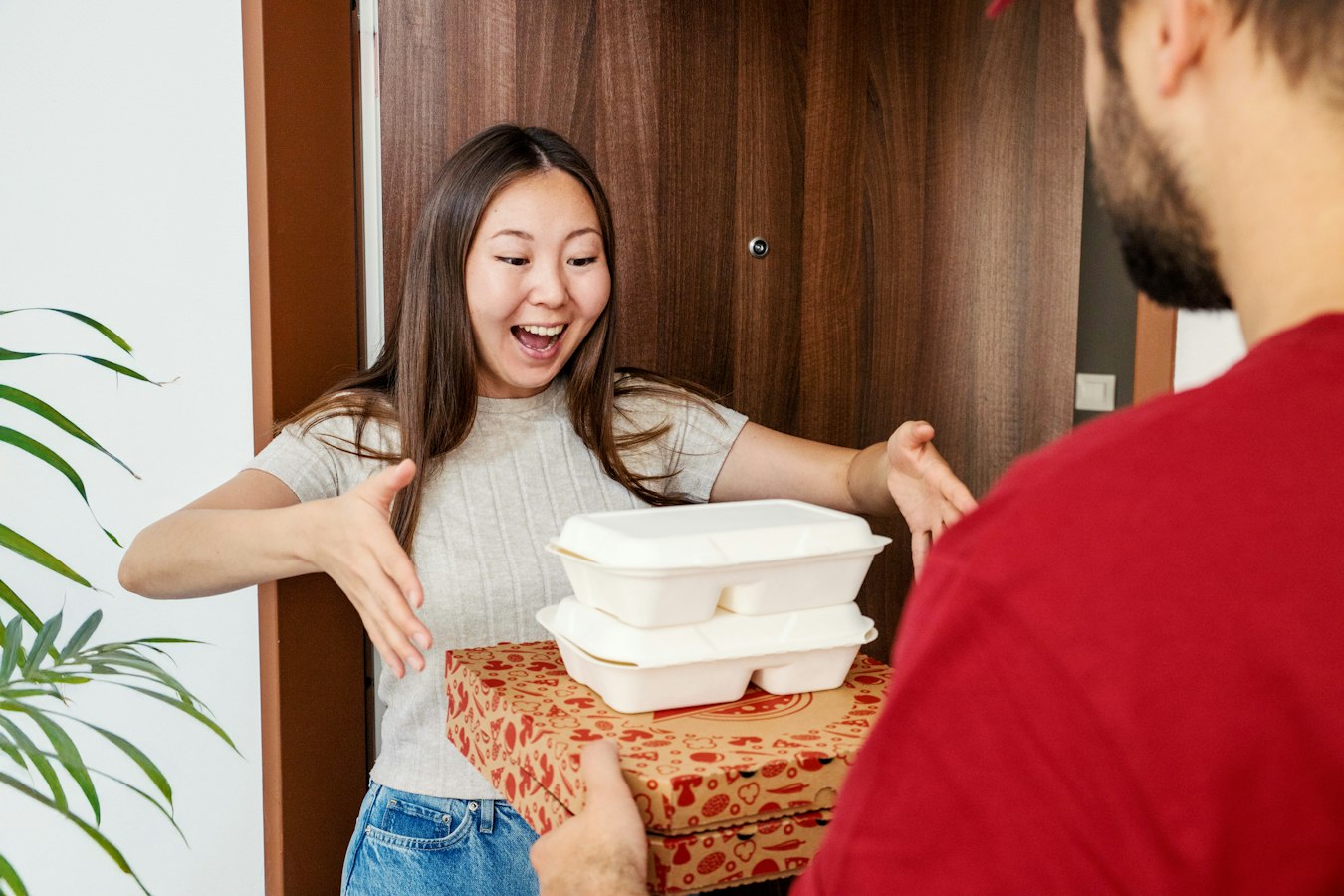 A customer photographing a delivered parcel with her phone